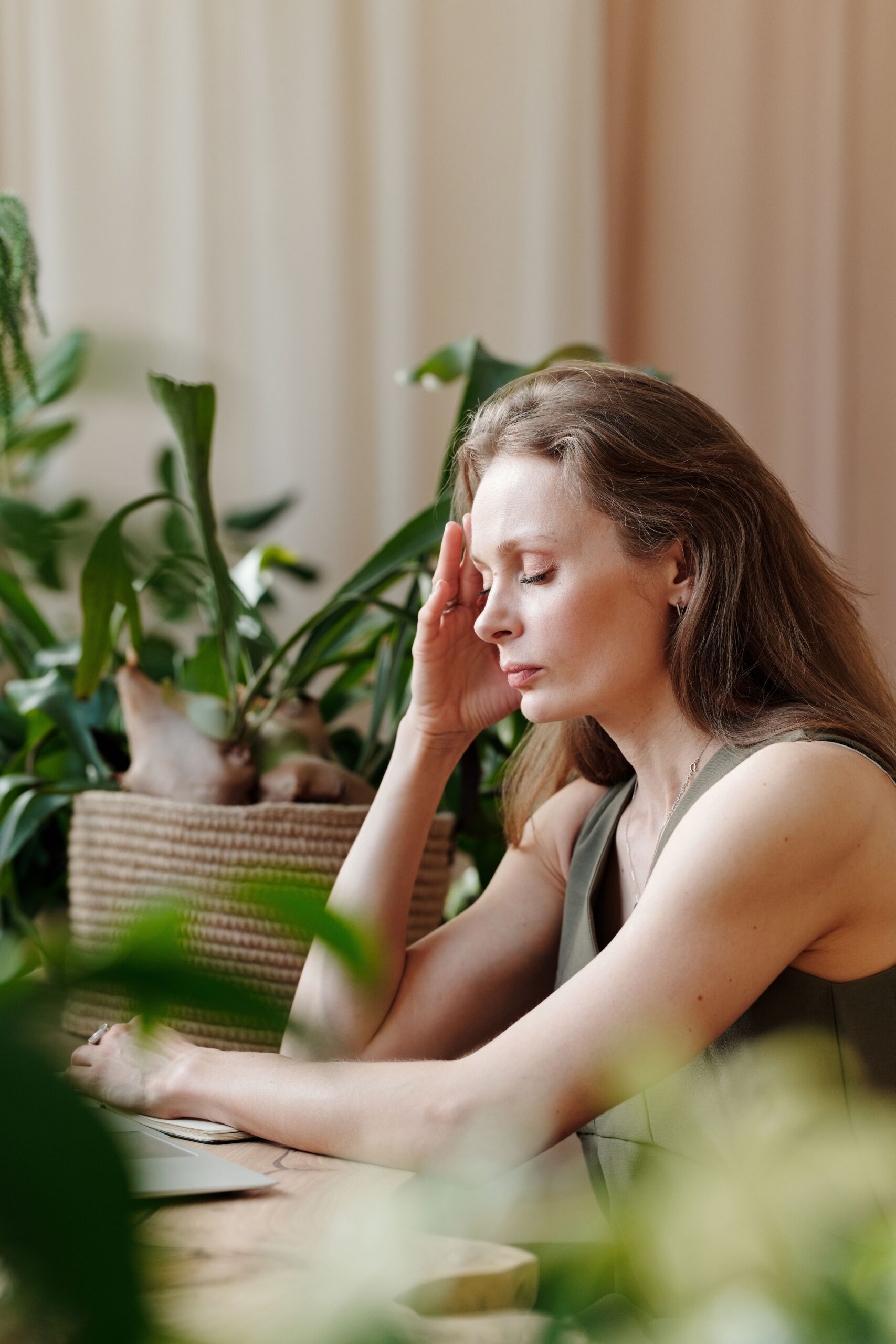 Women with headache trying to work.