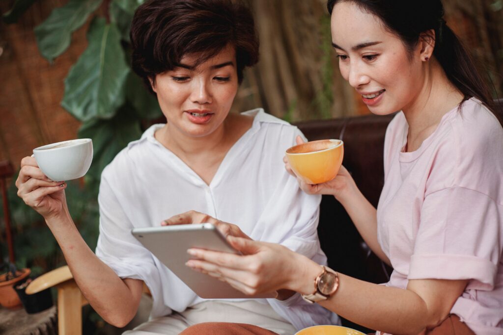 Woman smiling while reading good news about menopause support on her phone